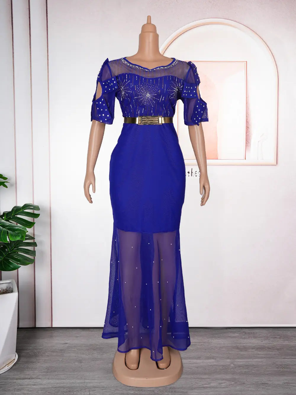A royal blue evening gown featuring heavy embroidered hot diamond beads with sheer beaded short sleeves and a matching translucent skirt.