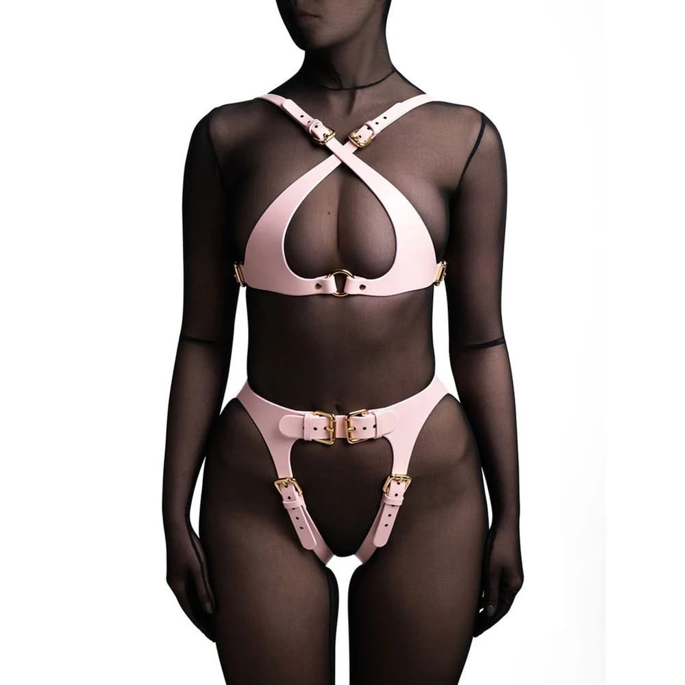 pink leather harness set with gold-tone buckles designed as performance accessories for stage costumes.