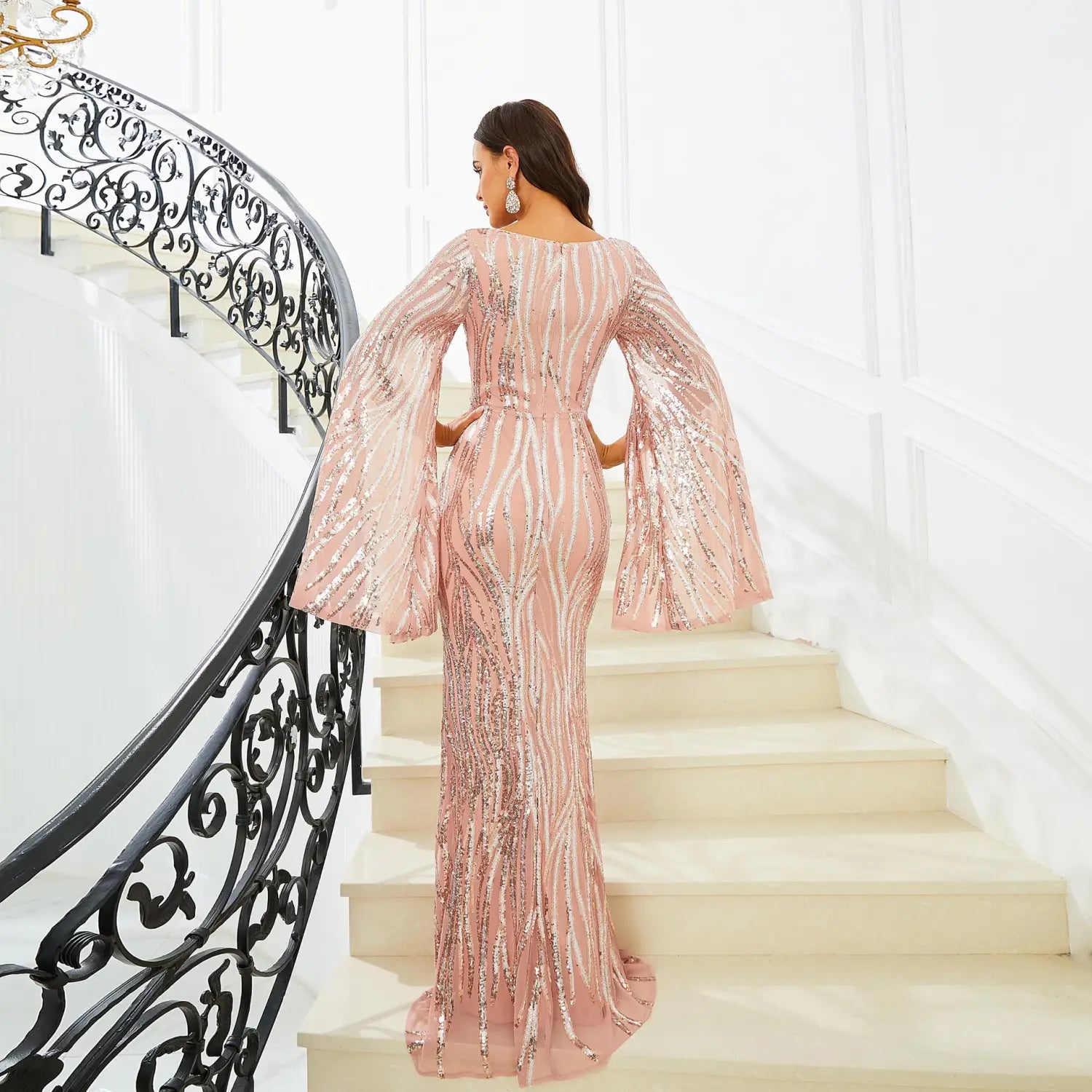 a shimmering rose gold long sleeve banquet sequined fishtail dress with bell sleeves and a fitted silhouette