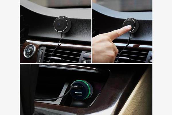 Black circular car hands free mount with green-accented charging port and attached cable for dual USB long press hands free phone music player.