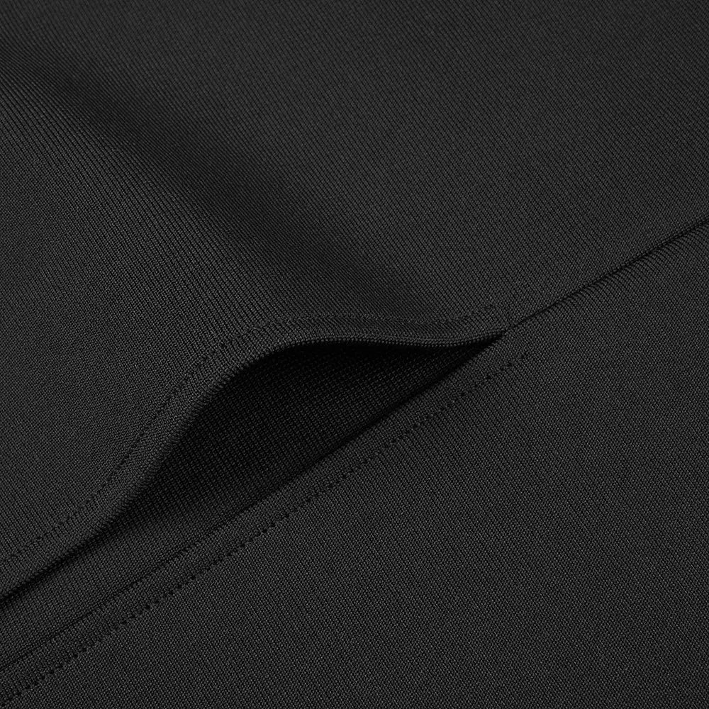black ribbed knit fabric with fine stitching detail on the folded edge of a black backless bandage chest gown with white floral accents