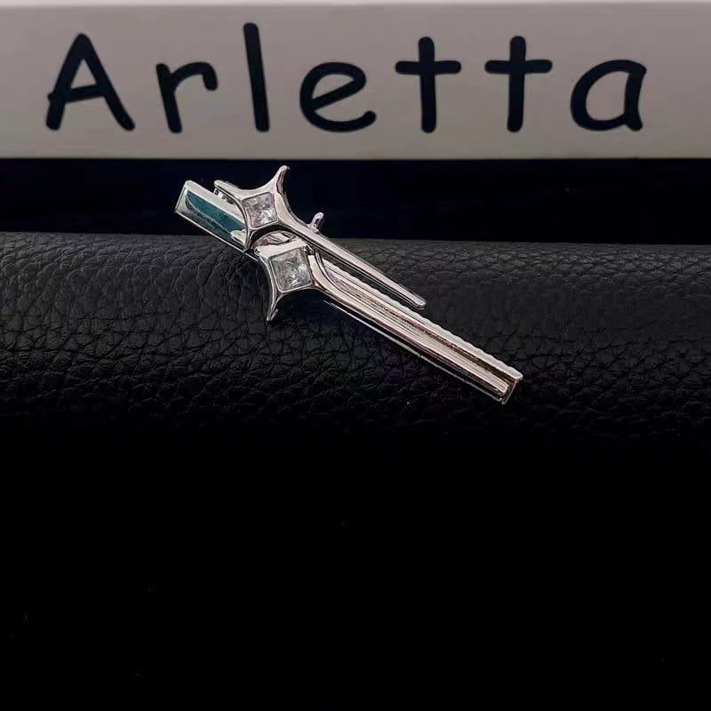 silver tie clip with a stylized sword design featuring clear gemstones and an emerald accent from the silver star y2g star hairpin collection perfect for hot girl y2g and girl y2g star looks.