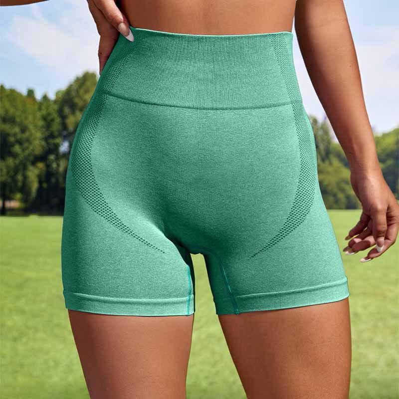 a pair of high-waisted mint green women sport seamless shorts featuring textured knit fabric and mesh panel detailing for athletic use