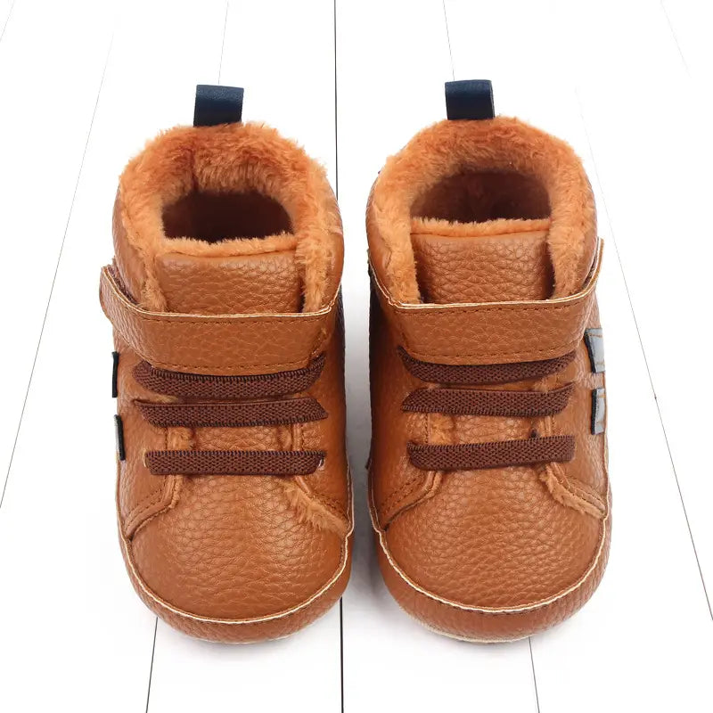 Brown leather baby shoes with plush orange lining and velcro straps featuring sports soft-sole cotton for comfort and flexibility.