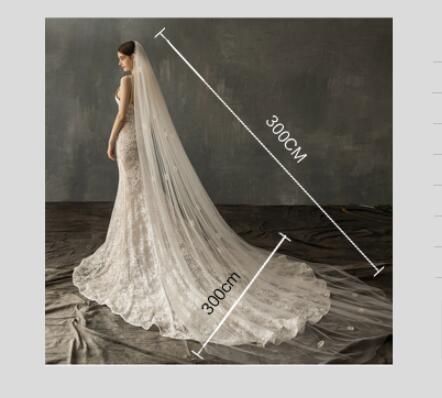 a flowing ivory lace bridal church wedding veil with an intricate pattern and a length of 300cm for a wedding pearl long tail gown