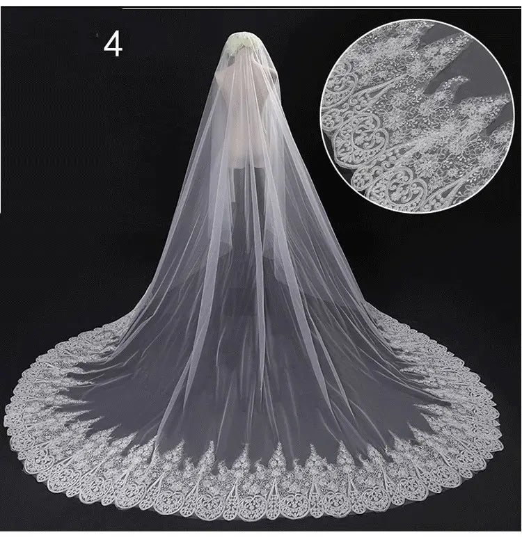 a sparkling wide style bridal wedding dress veil in white lace with intricate floral embroidery along its scalloped edge and attached hair comb