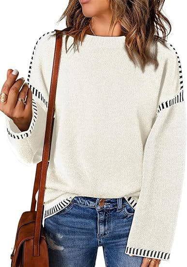 cream-colored solid round neck pullover knit sweater with black and white striped trim along the sleeves and hem