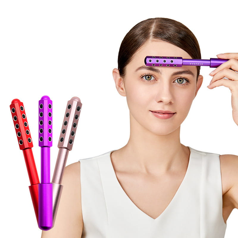 Purple metallic germanium beauty roller massage stick featuring a row of black circular indentations designed for facial massage.