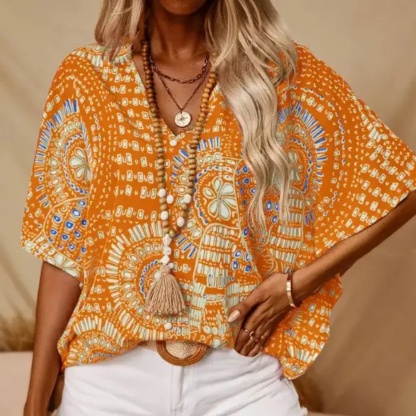 orange bohemian-patterned short-sleeve top with blue and white intricate designs featuring vacation style batwing sleeves