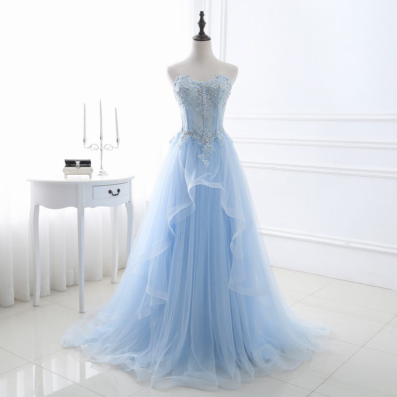 A light blue slim fit bridesmaid gown with a tied slim fit design featuring intricate silver beading and lace detailing on the strapless bodice made from layered tulle fabric suitable for an annual meeting.