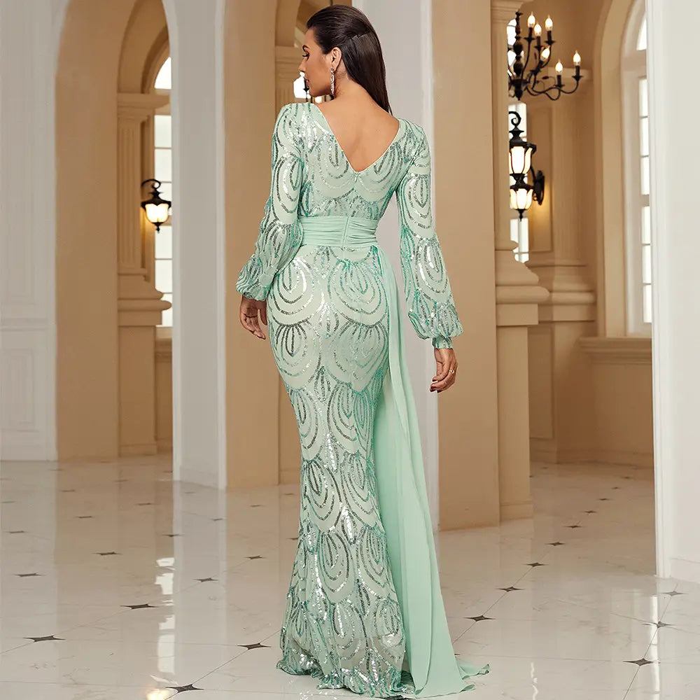 a shimmering mint green long sleeve sexy sequined evening dress with a mermaid-style silhouette and an elegant backless design shown from the back side