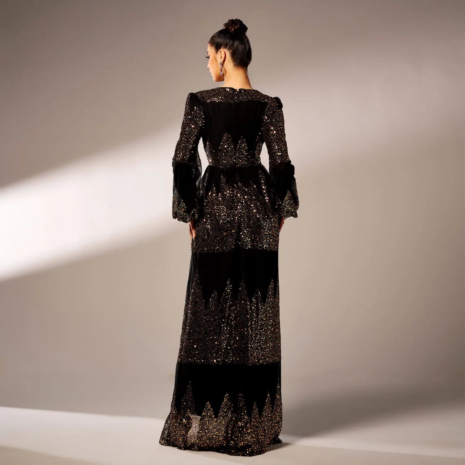 A black rust bell sleeve sexy long sequined evening dress featuring long sleeves, a glittering sequined bodice, and cascading sheer lace panels.