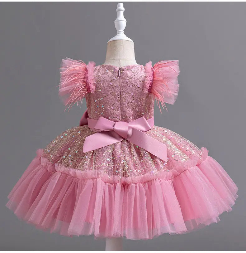 pink sequined toddler dress with feathered puff sleeves and a layered tulle skirt accented by a satin bow at the waist designed as a dress tulle skirt summer option.