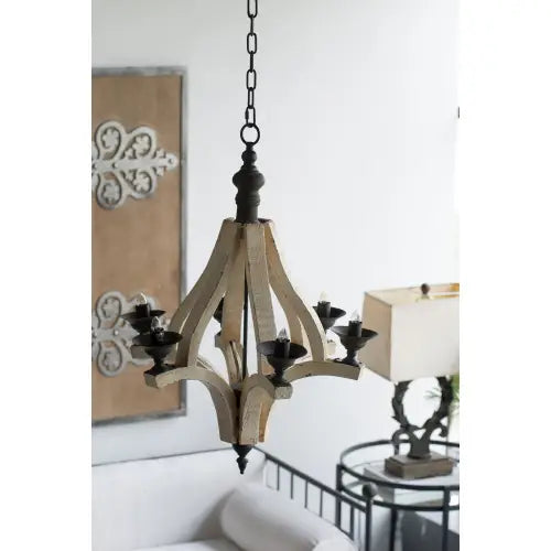 A rustic light wood chandelier with black metal accents and five candle-style lights designed for a dining hall entrance.