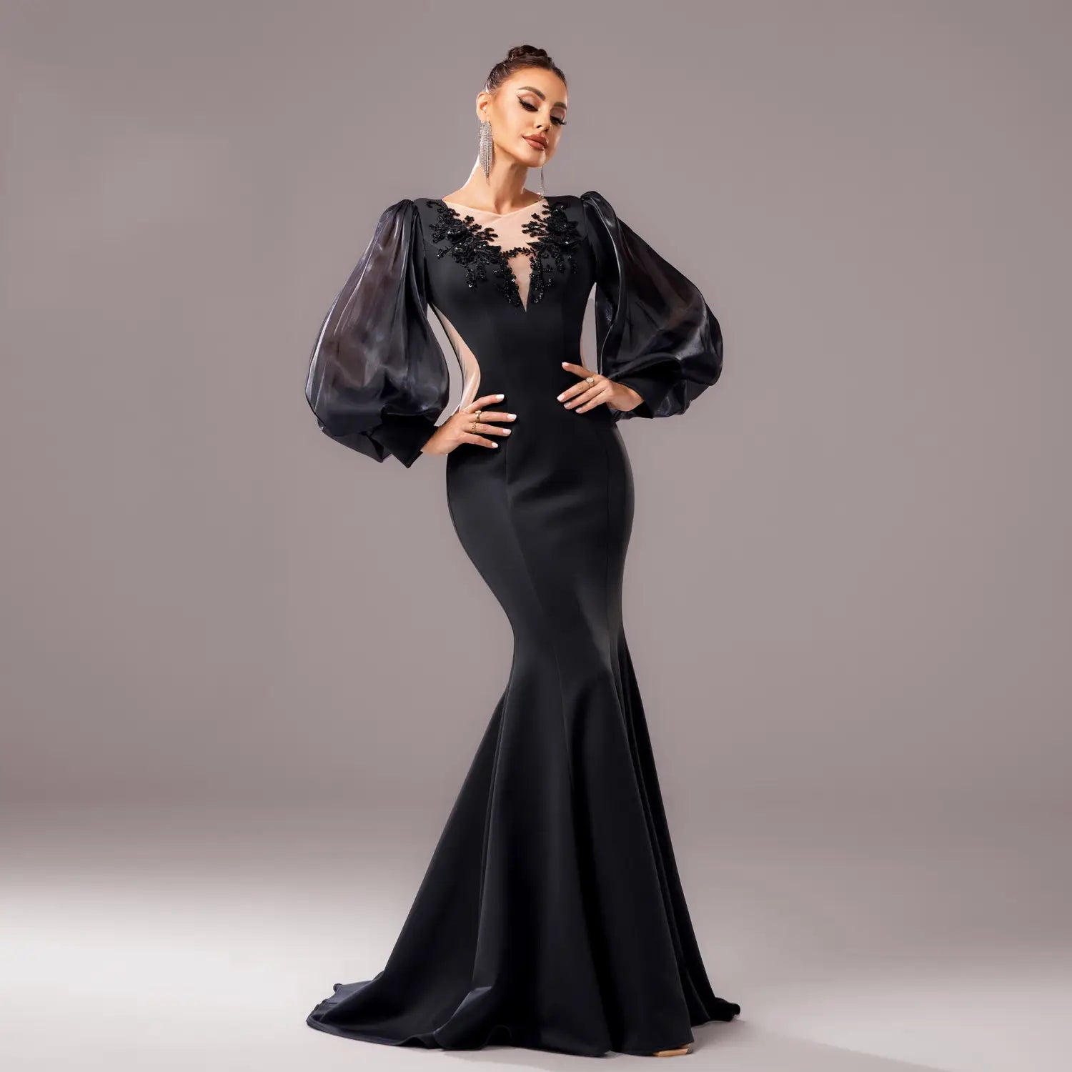 Elegant black beaded long sleeve round neck fishtail gown featuring sheer puffy sleeves and intricate lace detailing at the neckline.