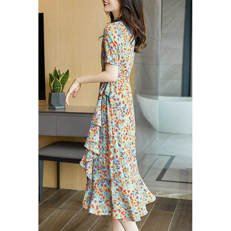 a flowing light blue french floral slim polka dot wrap dress featuring a vibrant orange and yellow floral pattern, short sleeves, v-neckline, and layered ruffles at the midi hem