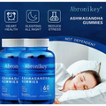 Blue glass bottles of abronikey ashwagandha vitamin d gummies with white caps and mixed berry dietary supplement labels