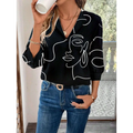 Black casual office blouse with abstract face pattern and three quarter sleeve length for women’s office wear