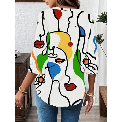 White casual office blouse with abstract face pattern in black outlines and bold red yellow green blue accents and long sleeves