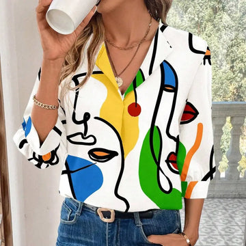 White blouse with bold abstract face pattern in yellow blue green and red on flowing fabric casual office blouse with sleeve length