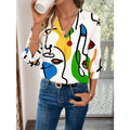 White casual office blouse with bold abstract face pattern in yellow blue green and red on cotton blend fabric