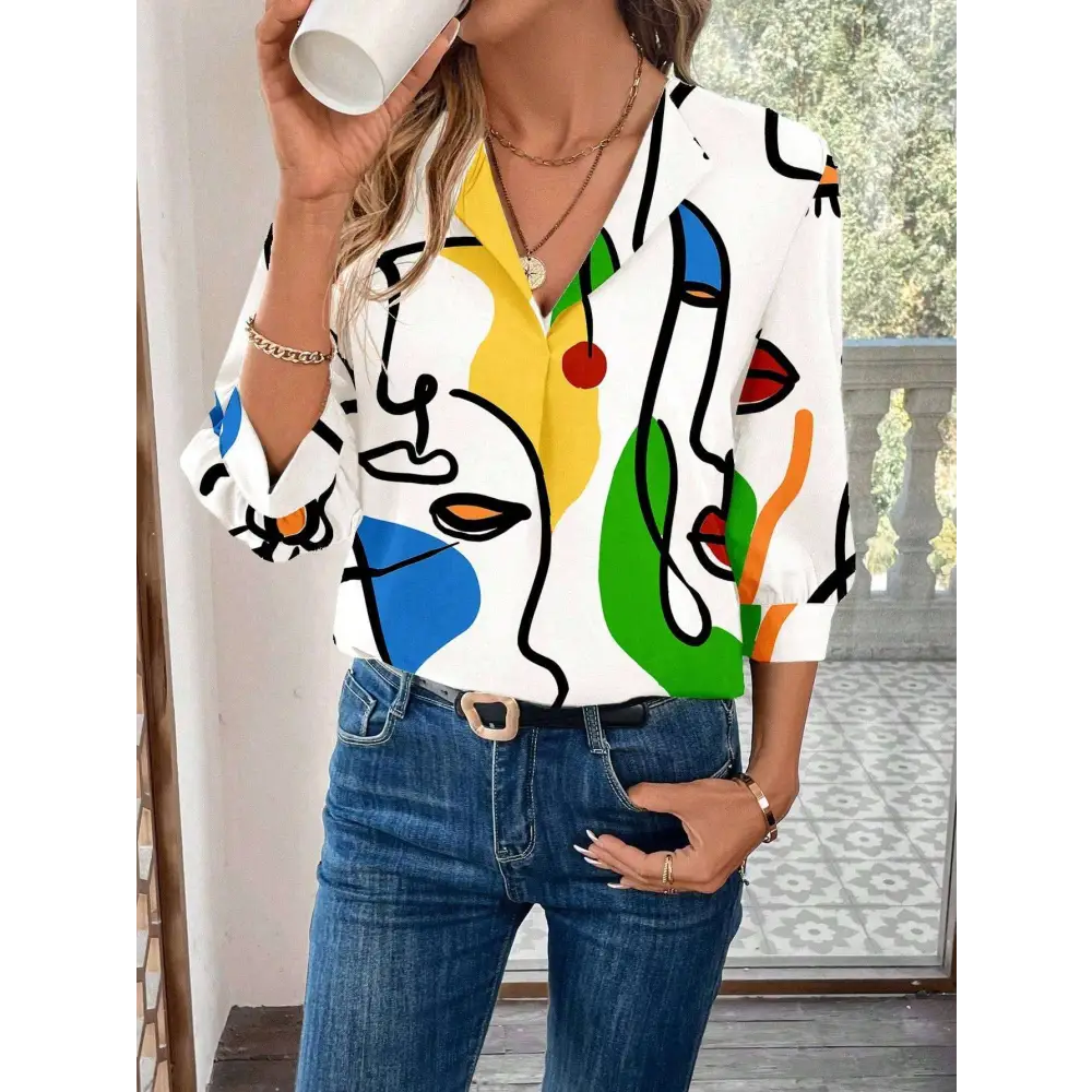 White casual office blouse with bold abstract face pattern in yellow blue green and red on cotton blend fabric