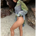 A loose-fitting long-sleeved printed bikini blouse with a bold green and black geometric pattern