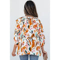 A woman wears a white chiffon shirt women with an abstract floral fashion colorblock printed pattern in orange pink teal and brown