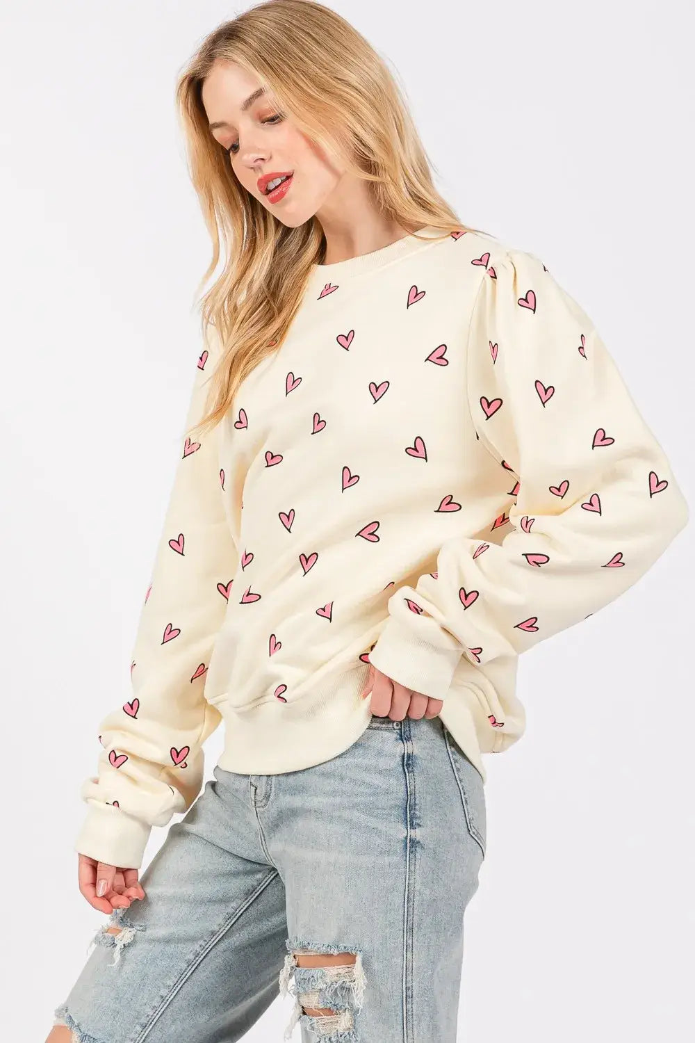 Cream-colored sage fig heart printed long sleeve sweatshirt featuring a soft cozy texture and an all-over pink heart print.