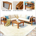 Outdoor acacia wood sofa set with cream cushions, blue accent pillows, and matching coffee table with rope armrests