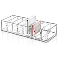 Clear acrylic makeup organizer with compartments holding multiple items including white phone and pink card