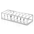 Clear acrylic makeup organizer with ten rectangular compartments holding multiple cosmetics efficiently