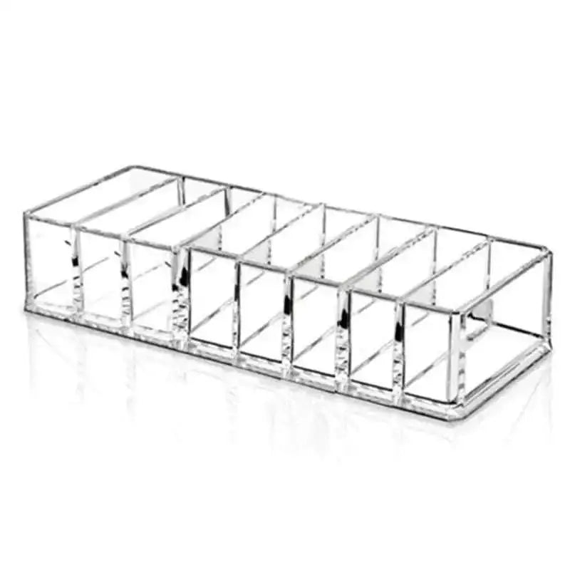 Clear acrylic makeup organizer with ten rectangular compartments holding multiple cosmetics efficiently