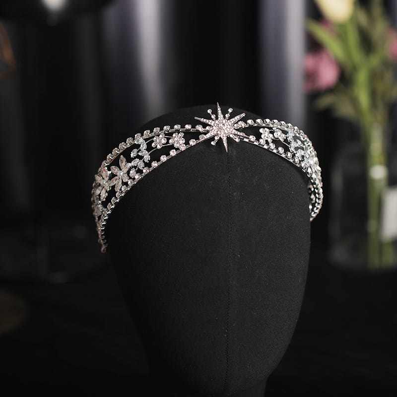 A sparkling silver bridal crown headdress with intricate floral and starburst designs featuring clear zircon crystals set in a delicate metal framework.