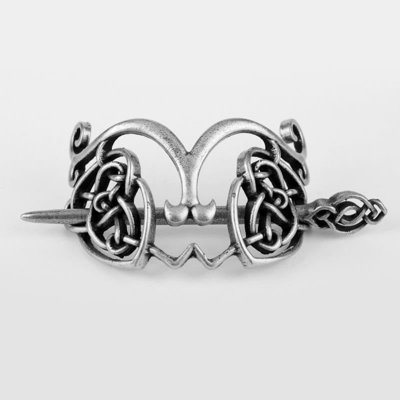 Silver-toned metal hair clip with intricate Celtic knotwork and a central heart-shaped motif, featuring decorative ends for a stylish metal hair accessory.