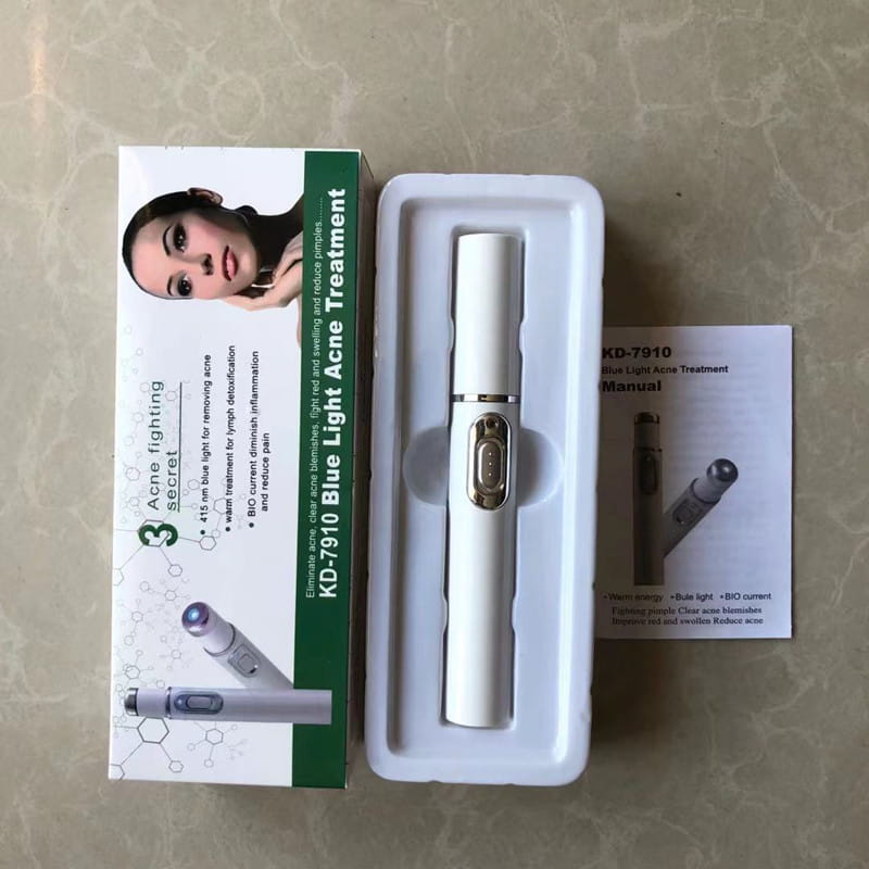 White cylindrical blue light therapy acne laser pen with gold-colored button and metallic accents for light therapy acne treatment