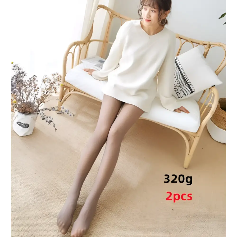 Sheer nude-colored adjustable maternity pantyhose tights worn by a woman seated on a rattan bench for comfort