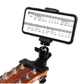 Black adjustable phone guitar clip stand with clamp holding smartphone displaying sheet music above acoustic guitar for live streaming