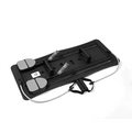 Black plastic adjustable pilates sliding board with gray foot pedals and resistance bands to enhance flexibility