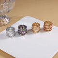Adjustable rhinestone bracelet and fashion rings set featuring four expandable jeweled napkin rings in silver, iridescent, gold, and red