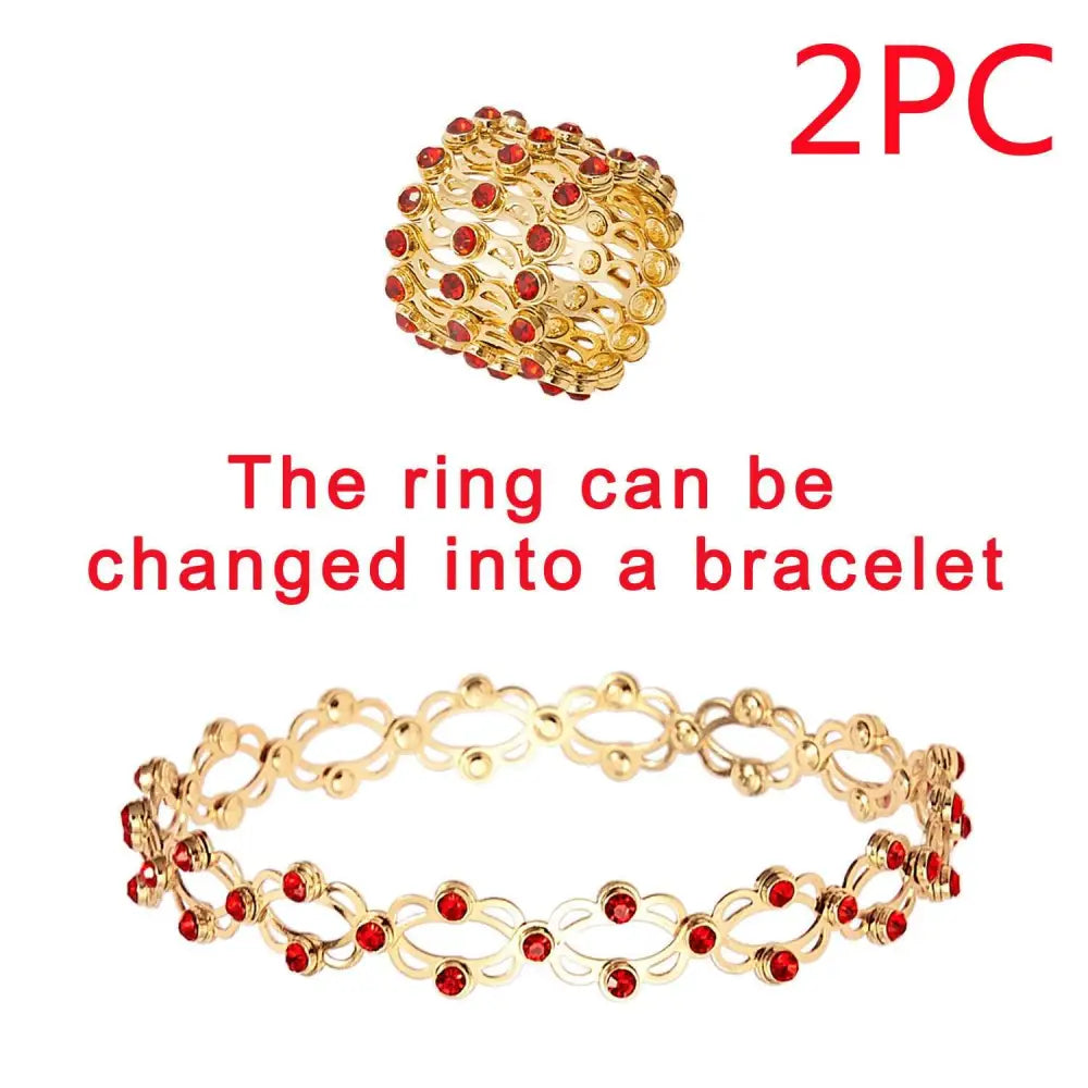 Gold-colored adjustable rhinestone bracelet and fashion rings set with red gemstones in a multi-layered design