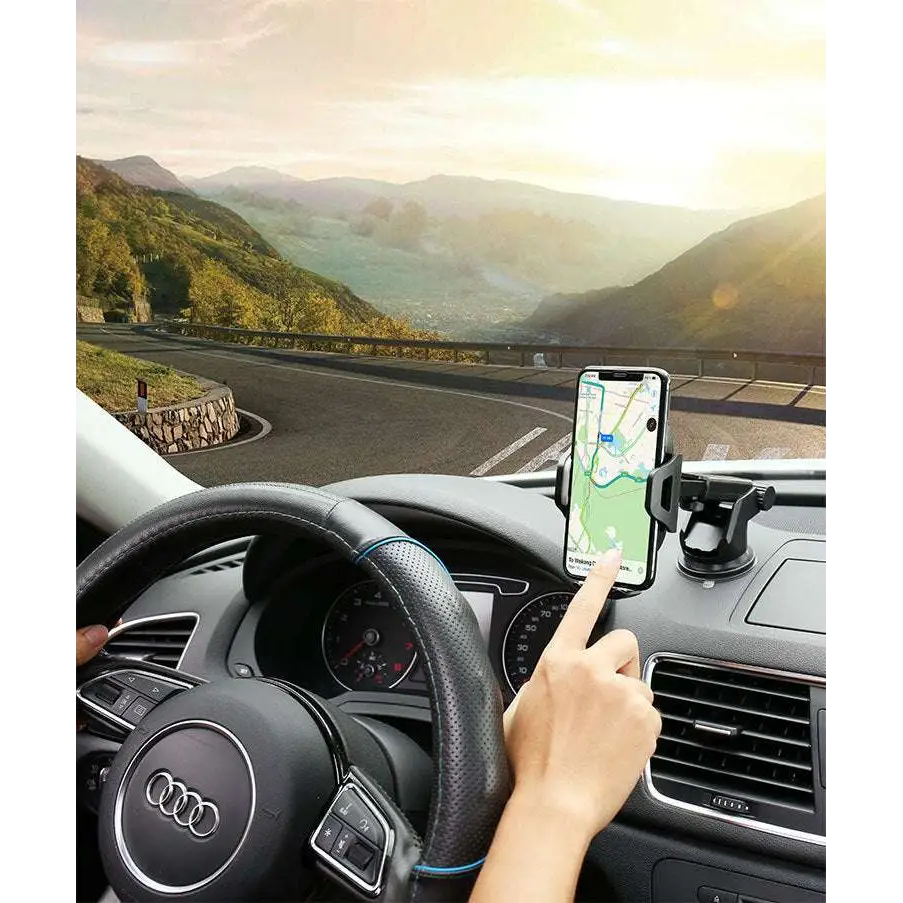 Black smartphone mounted in car phone navigation bracket with adjustable suction cup and arms on dashboard holder