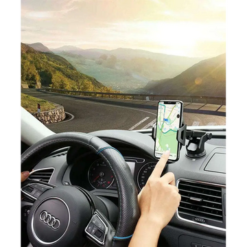 Black smartphone mounted in car phone navigation bracket with adjustable suction cup and arms on dashboard holder