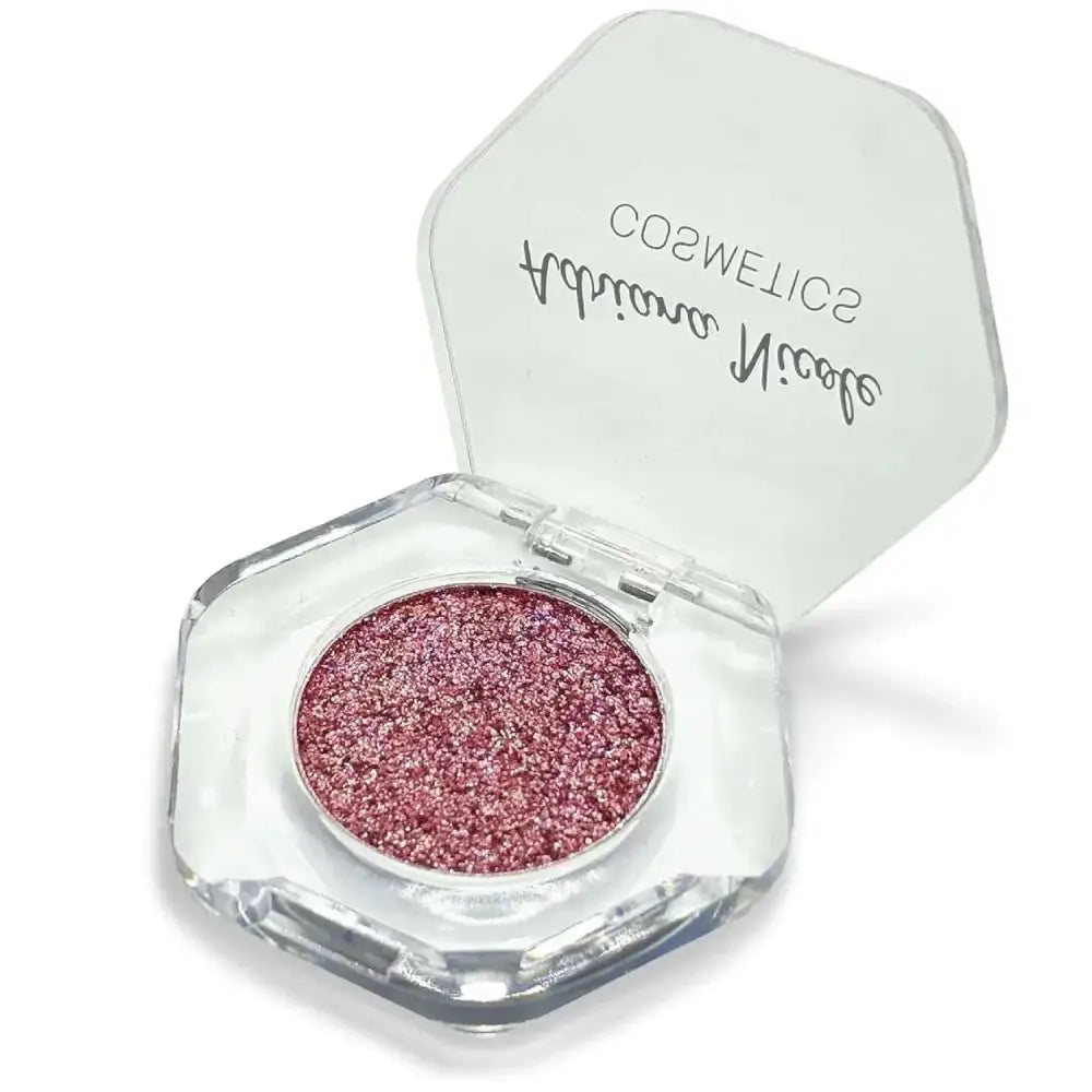 A hexagonal transparent compact of adriana nicole rose gold shimmer eyeshadow single with brand name on lid