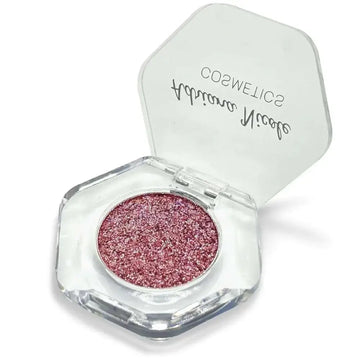 A hexagonal transparent compact of adriana nicole rose gold shimmer eyeshadow single with brand name on lid