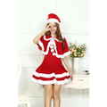 Adult female christmas velvet santa dress in red and white with fluffy trim pom-poms and matching hat