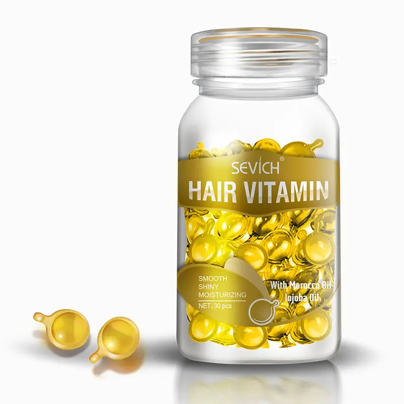a transparent glass bottle of sevich multicolor hair care capsules containing golden gel capsules with small stems for hair care benefits