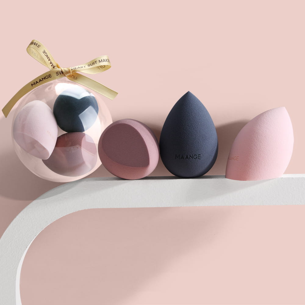 set of soft pastel and navy blue spherical beauty egg makeup sponges made of silicone in teardrop shapes with maange branding.