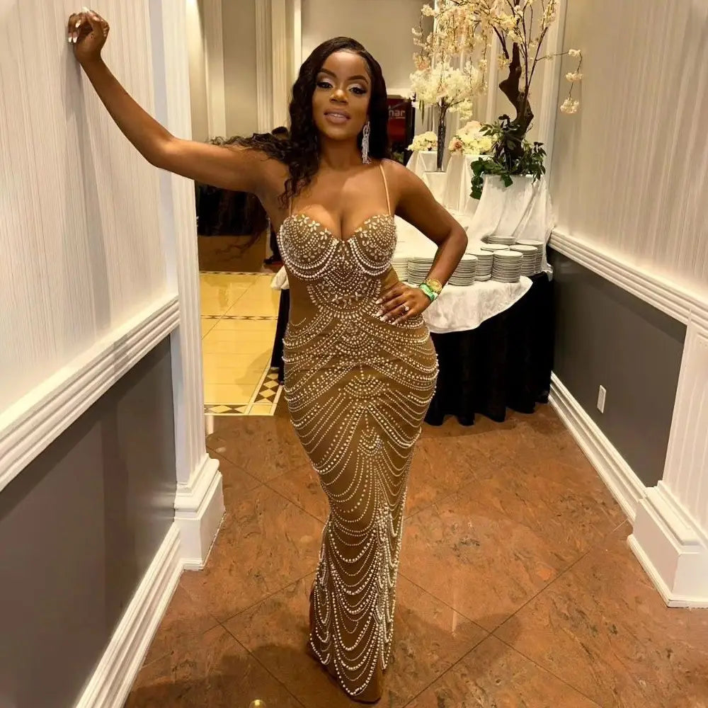 A shimmering gold mermaid-style evening dress featuring intricate sling hot drilling geometric beadwork and pearl-like embellishments cascading down the bodice and skirt.