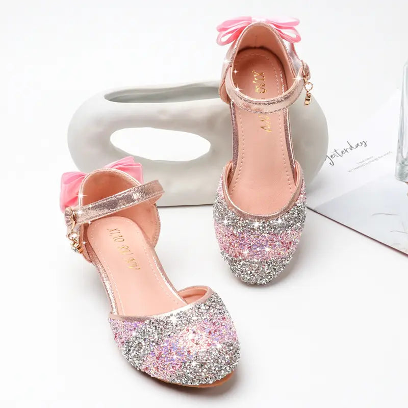 pink and silver glittery girls high heel summer sandals with a bow on the strap and rhinestone sparkling detailing